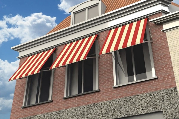 Rood-wit gestreepte uitvalschermen aan een bakstenen huis Rood-wit gestreepte uitvalschermen aan een bakstenen huis