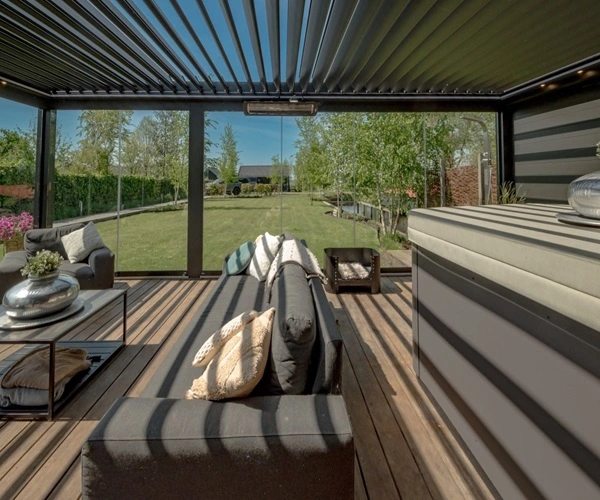 Buitenterras onder een kantelbare lamellen overkapping met comfortabel meubilair Buitenterras onder een kantelbare lamellen overkapping met comfortabel meubilair