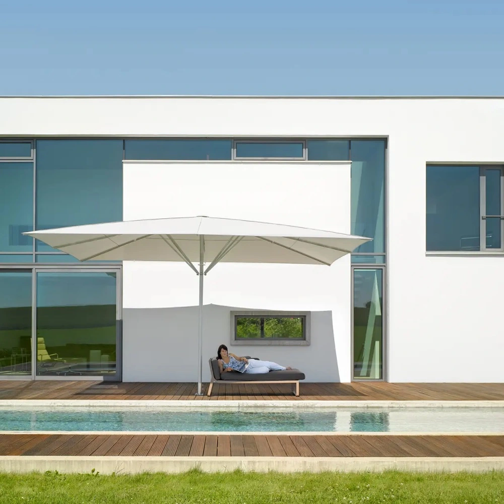Parasol Schatello bij luxe zwembad aan modern huis met ligstoel