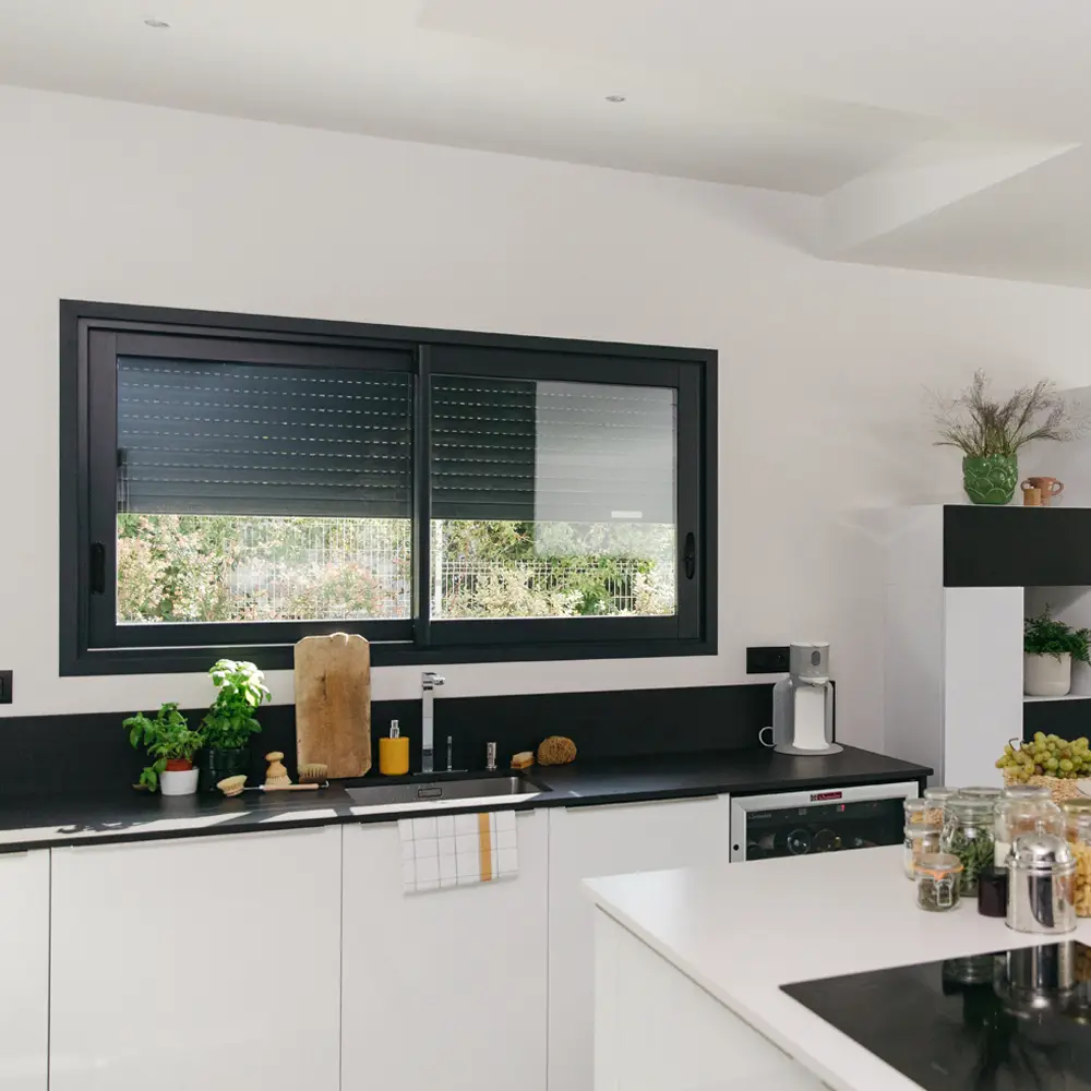 Witte keuken met raam waarvan rolluik half dicht is