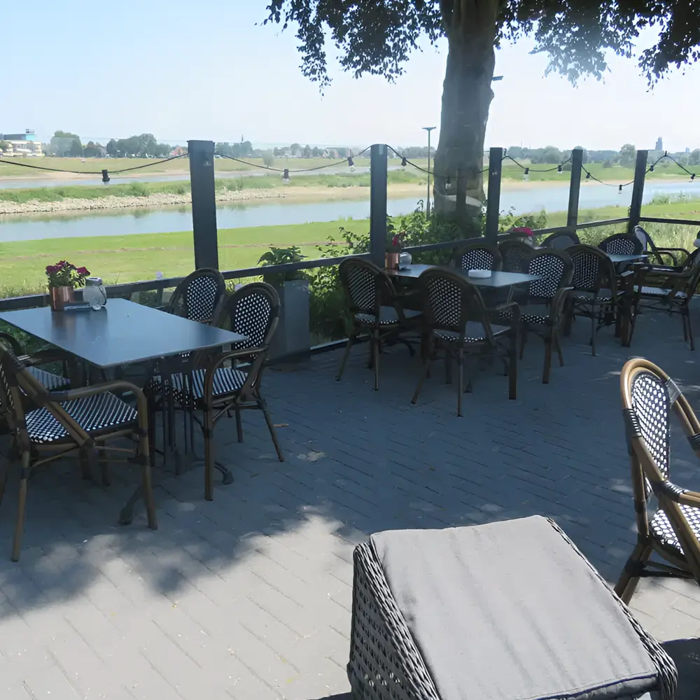 Horecaterras met windscherm Belles aan de rivier met stoelen en tafel
