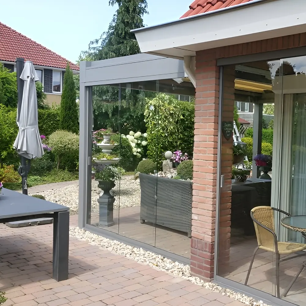 Glazen schuifwand van Nomo tuinkamer met uitzicht op tuin en zithoek