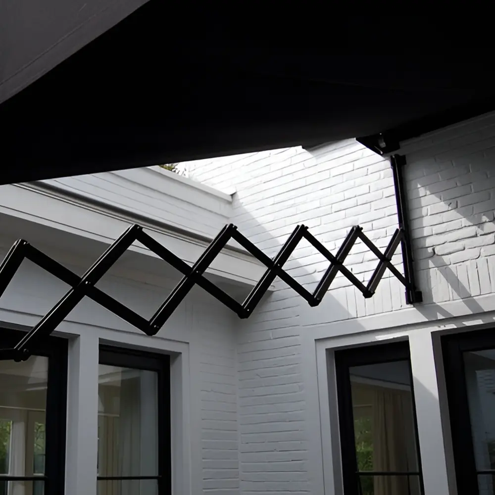 Schaararmscherm boven terras in groene tuin bij witte woning