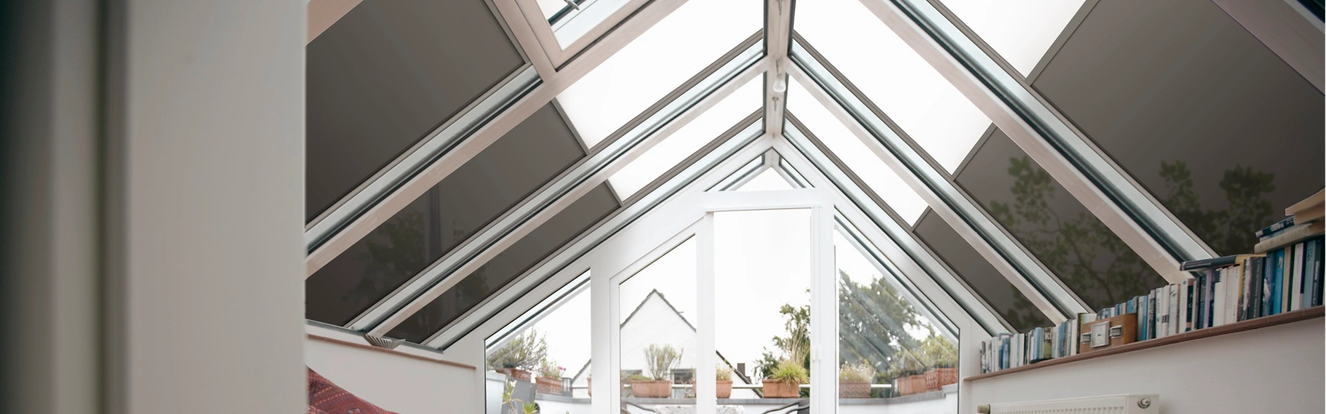 Binnenaanzicht van een serre met VZ 0800 zip solar zonwering en schuine dakpanelen