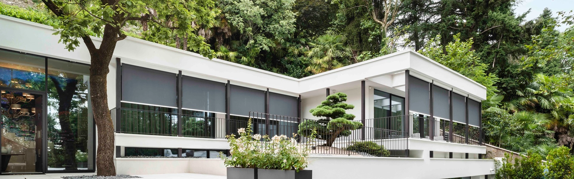 Click Cable screen zonwering aan woning met grote tuin en bomen