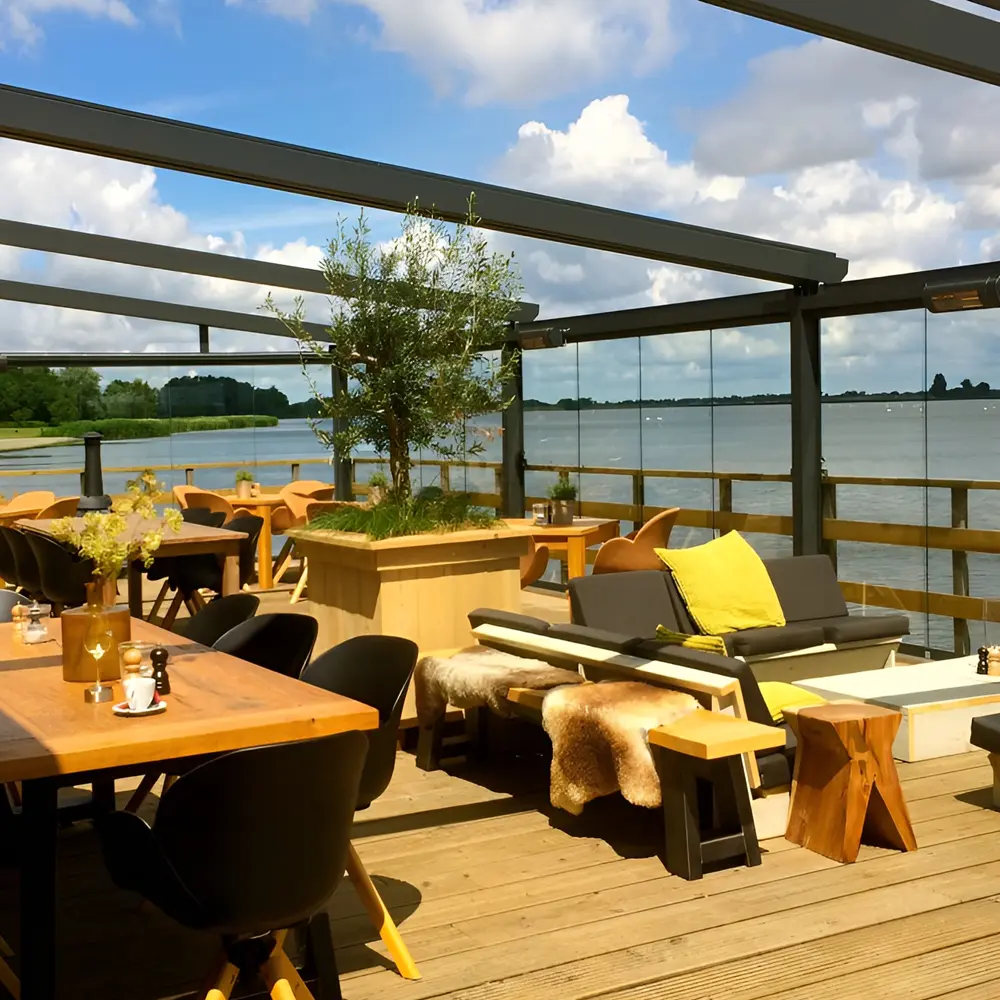 Luxe terras met glazenschuifwanden, houten meubels en uitzicht op het meer