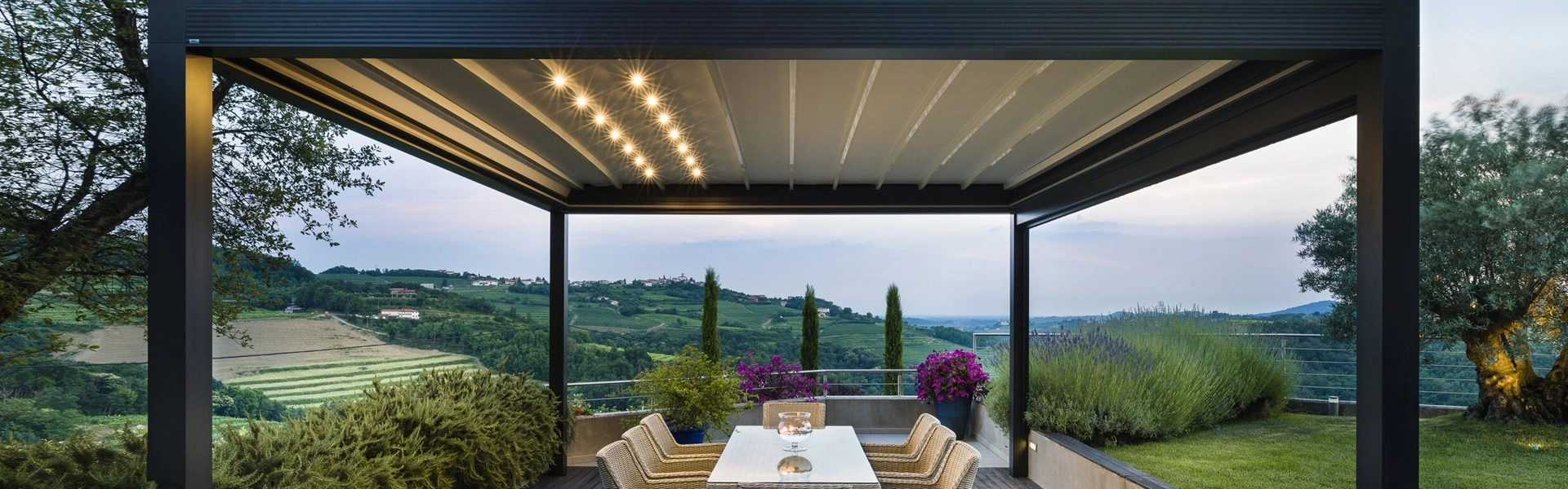 Moderne buitenruimte met ledspots onder een lamellenoverkapping