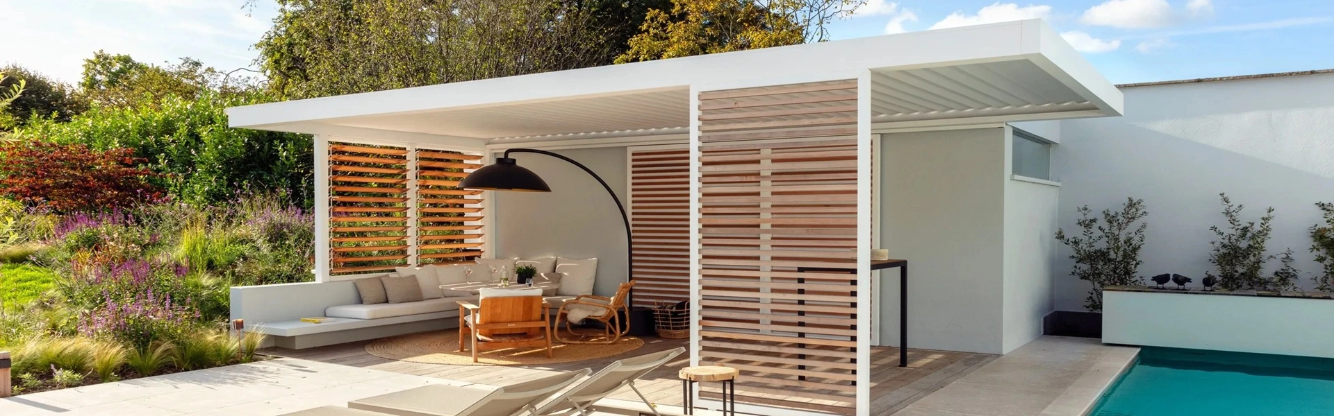 Tuinkamer met houten en aluminium details bij een zwembad